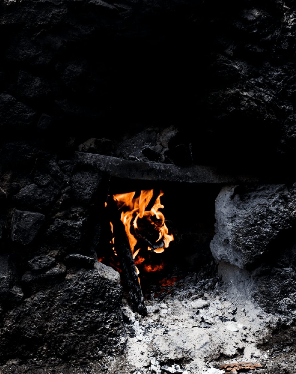 Fire and coals in the courtyard during Blasfemus Nights in Roma, Texas