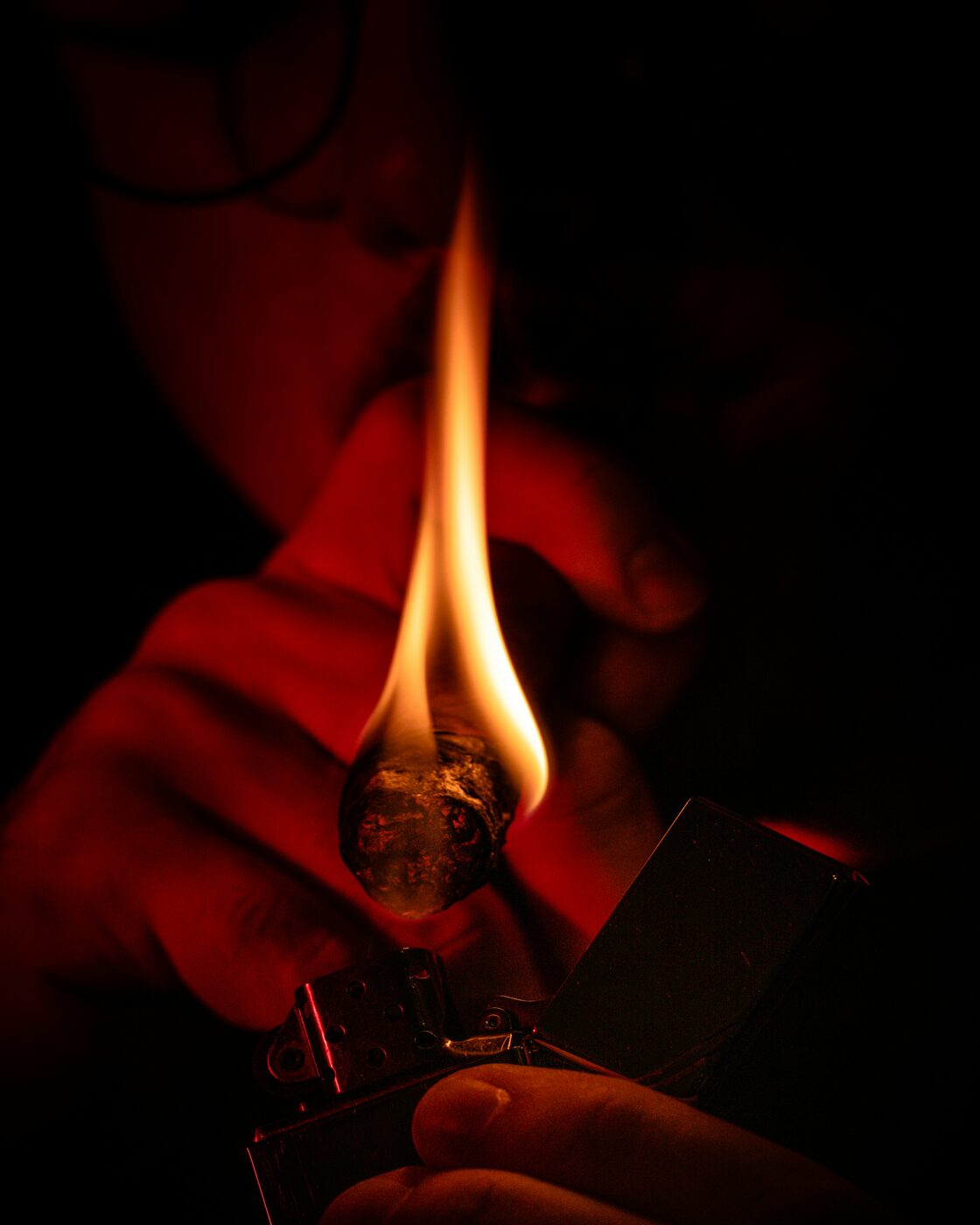 A cigar being lit at the Cigar Club at Ancestral Craft Spirits