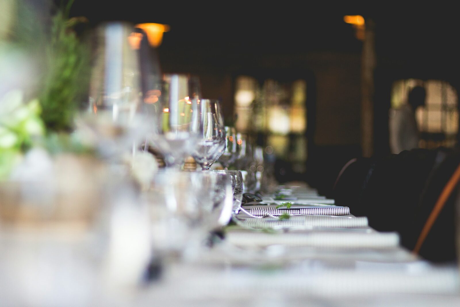 A long private dinner table set among the barrels at Ancestral Craft Spirits, Roma, Texas
